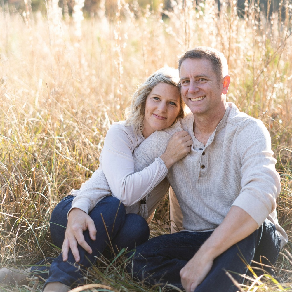 A couple seated in a wheat field